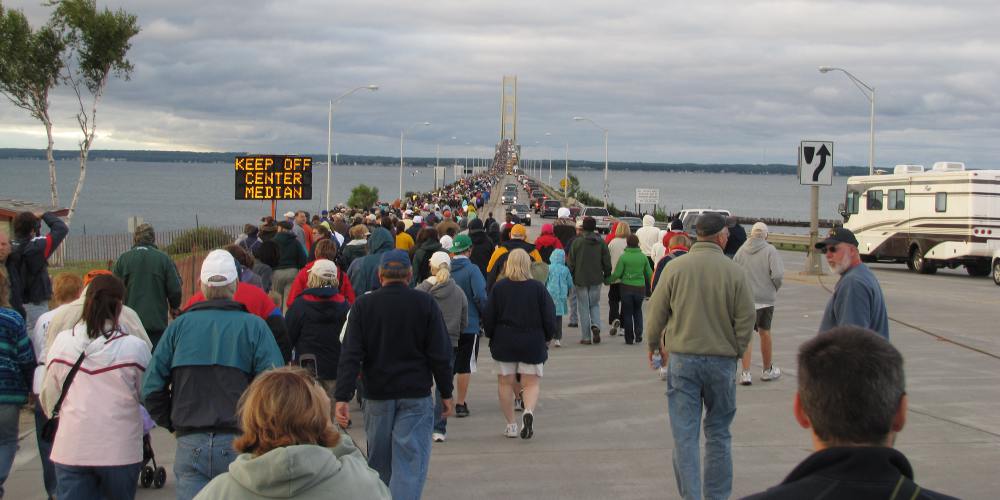 Walkers at the foot of the Mackinac Bridge