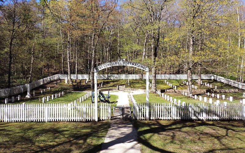 US Post Cemetery picket fence, arched sign and turnstyle