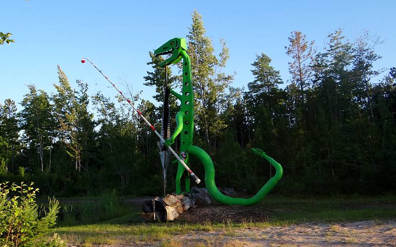 Fishing dinosaur sculpture