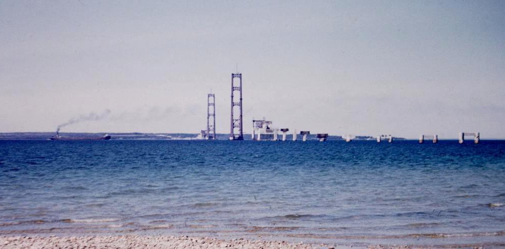 freighter and Mackinac Bridge construction