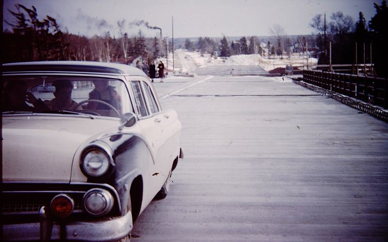 Tourists on the as yet unfinished Mackinac Bridge