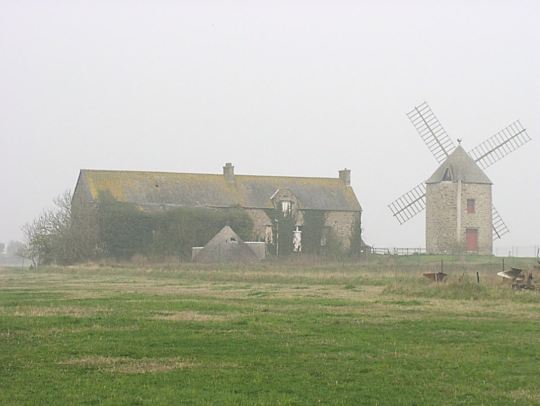 Brittany farm and windmill in the mist