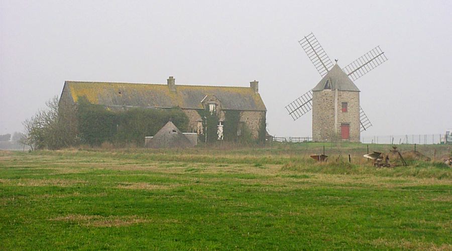 Brittany farm and windmill in the mist
