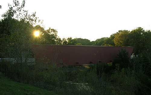 Sun settnig behind Hallowell Covered Bridge